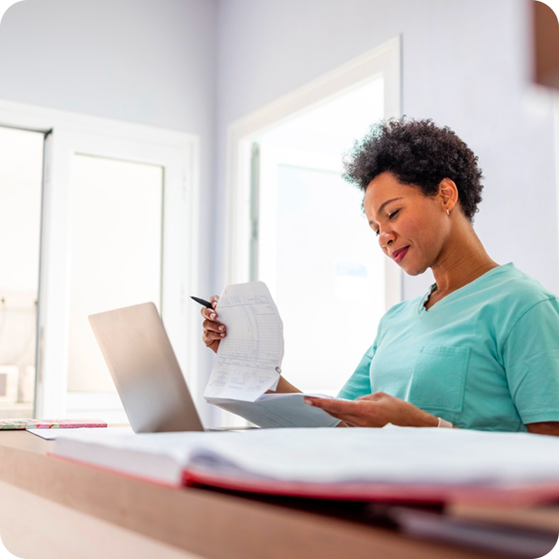 A nurse looking at paper work. 