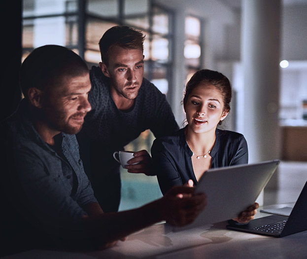 Co-workers looking at a laptop.